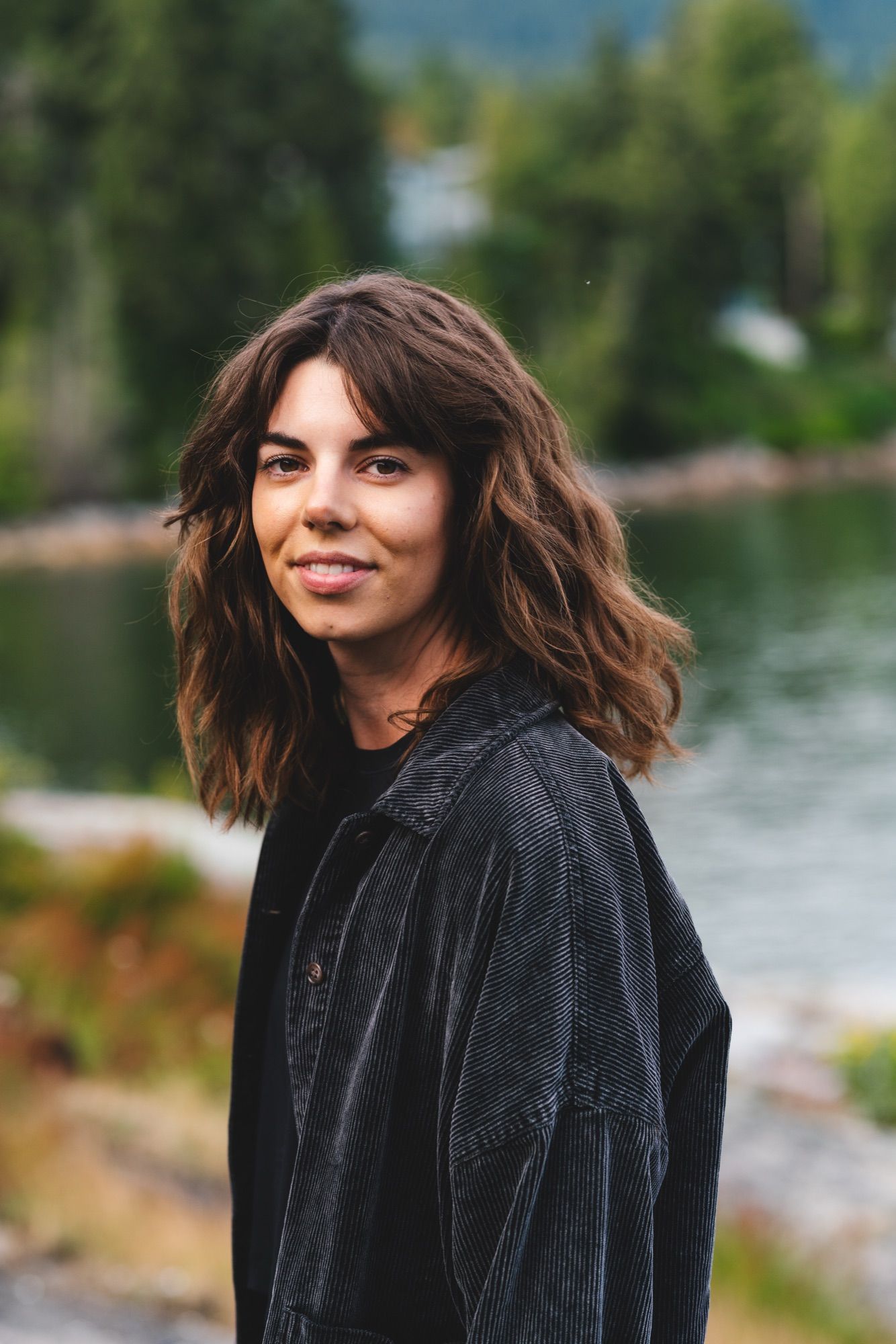 Emily Potts, smiling, by the water
