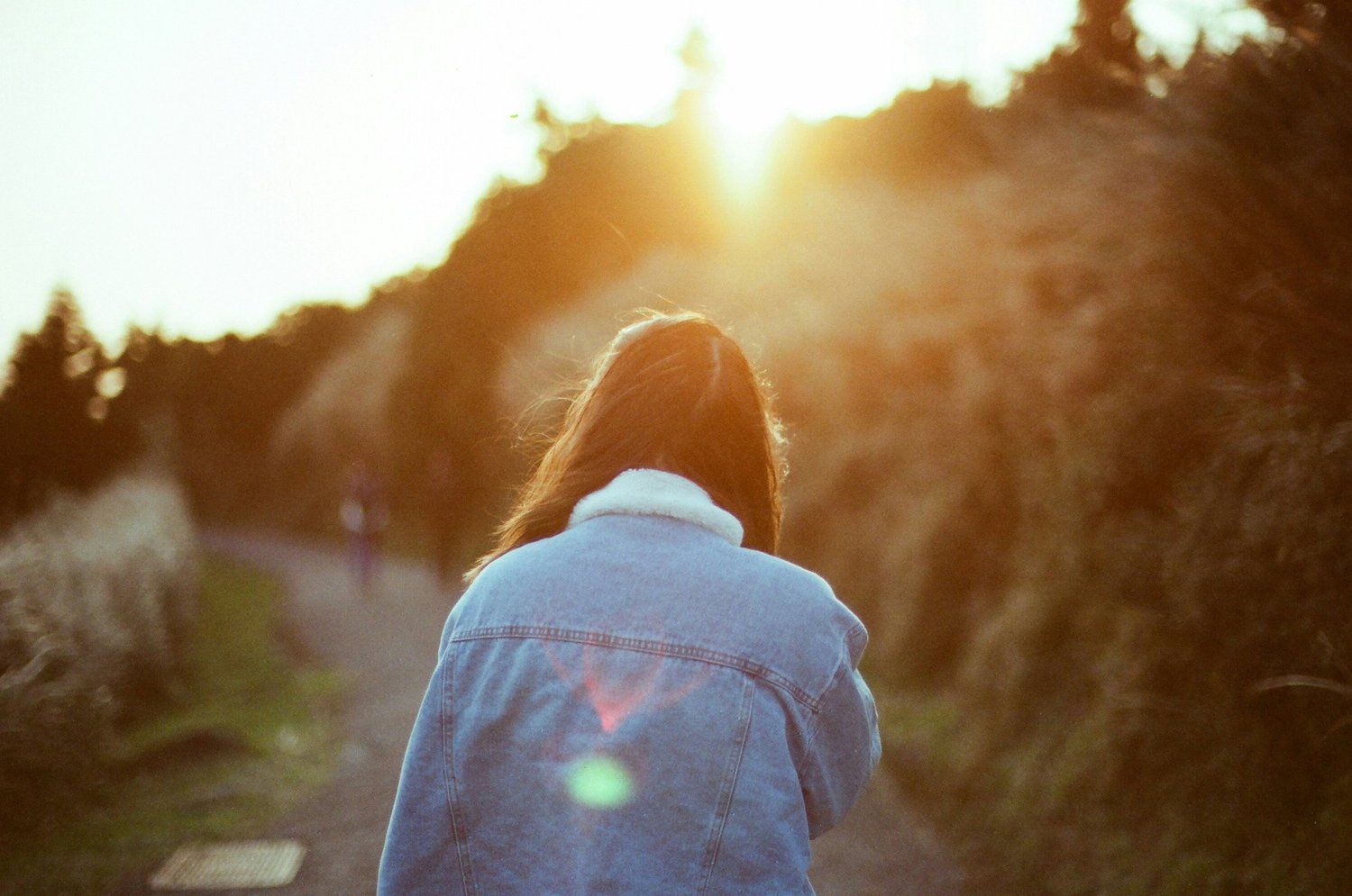 A person walking a sunlit trail